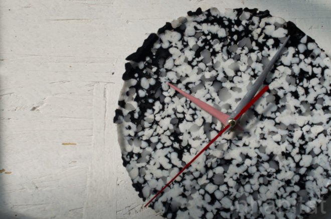 S-Lab Clock by 4R is a black, white and gray speckles clock with red and gray bars.