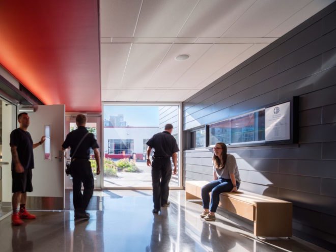 People walk through a room inside the station