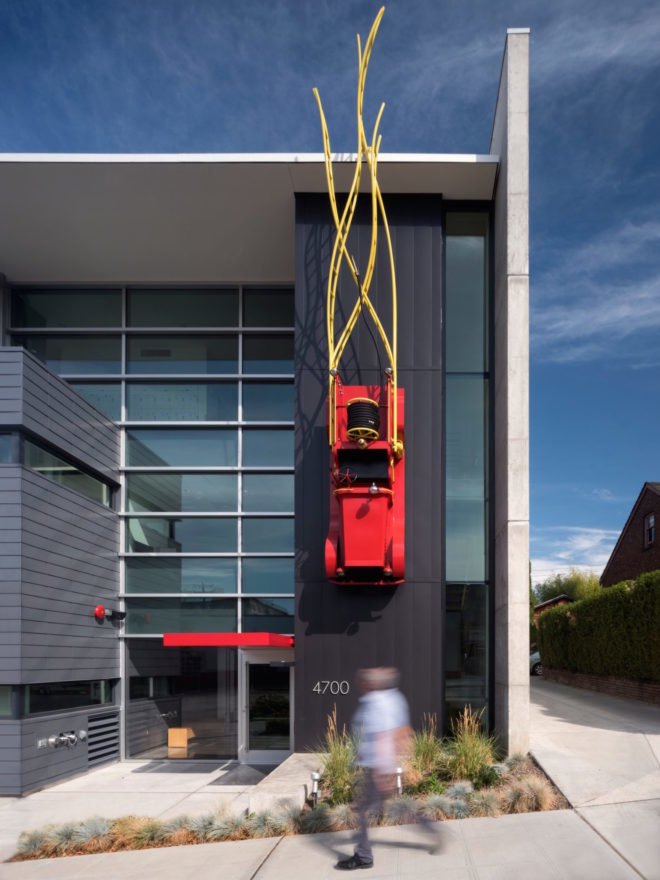 Fire truck art suspended from the building