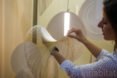 Woman touches the OLED panel inside the Sila lamp.
