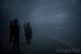 People stand inside the misty dome.