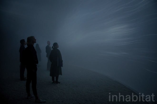 People stand inside the misty dome.