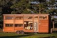 The Traveler XL features plenty of windows and wood siding.