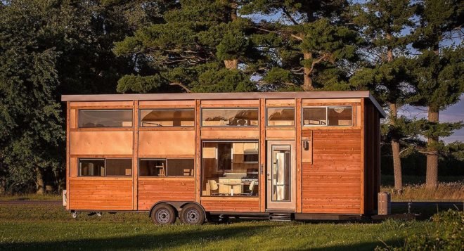 The Traveler XL features plenty of windows and wood siding.