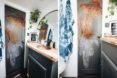 bathroom with grey door and wall decor
