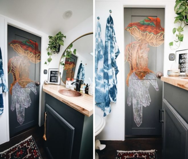 bathroom with grey door and wall decor