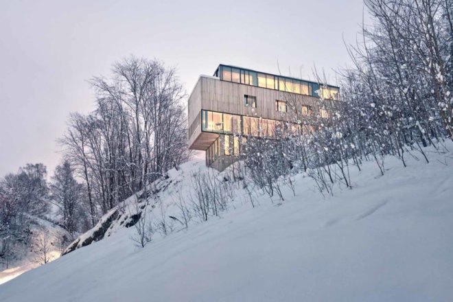 The home is set on a concrete base Two-in-One House by Reiulf Ramstad Arkitekter