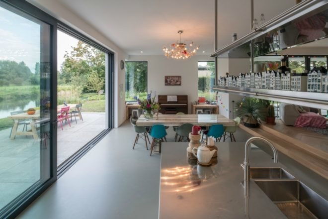 Beside the indoor dining area is a large sliding glass door that leads to the outdoor patio and dining area.
