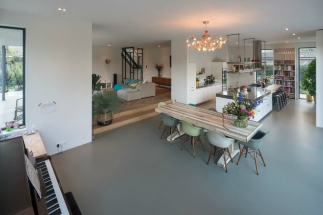 This image of the dining and kitchen space shows the open floor plan that is prominent throughout the renovated home.