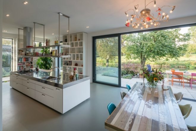 This image shows the wooden dining table and the large kitchen island.