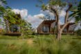 The three bungalows are surrounded by greenery.