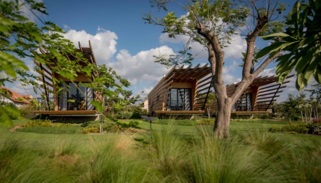 The three bungalows are surrounded by greenery.