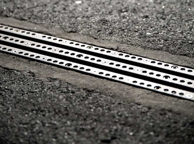 A close-up of the electric rail found on the road surface.