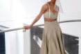 Model wears a cropped top and ankle-length skirt.
