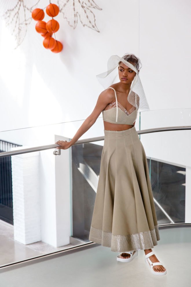 Model wears a cropped top and ankle-length skirt.