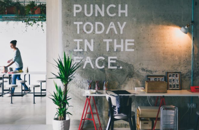 An office wall says, "Punch today in the face."
