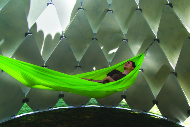 person napping in hammock inside the gazebo