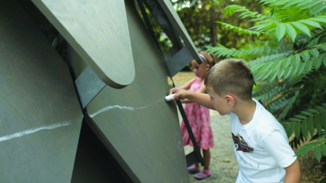 child drawing with chalk