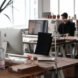 An office has desks, but no cubicle walls.
