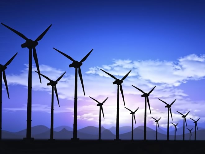 Wind turbines against a setting sun