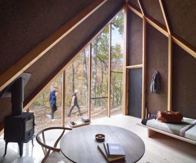 View of two people and a forest through a triangular window