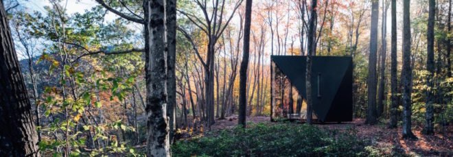 A triangular tiny house in the woods