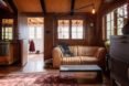 Living area with tan leather couch and patterned rug