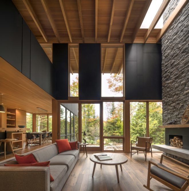living room with long gray couch and tall ceilings