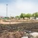 An urban farm with a radio tower in the background