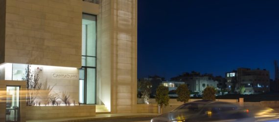 A bank at night with an illuminated facade and stairway