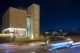 A bank at night with an illuminated facade and stairway