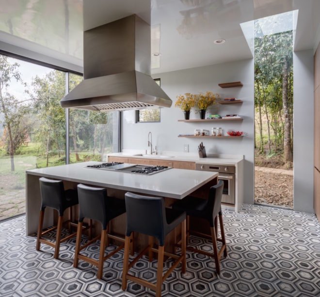 The kitchen has large glass windows and a modern island