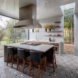 The kitchen has large glass windows and a modern island