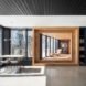 An airy living space with windows, a table, and lounge chairs
