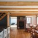 exposed timber trusses in a wood floored living room