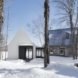 A rustic cabin and its modern white painted extension