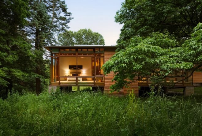Large glass windows showcases the bedroom from the outside