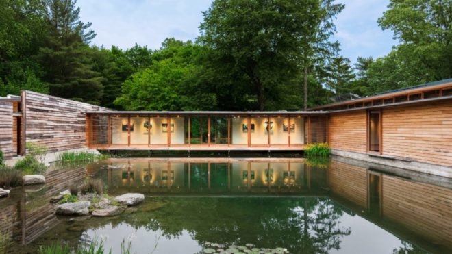 Glazed bridge connects two volumes of the home