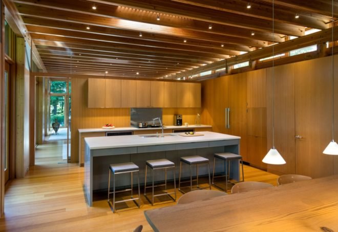 Timber kitchen with light-colored island and four stools