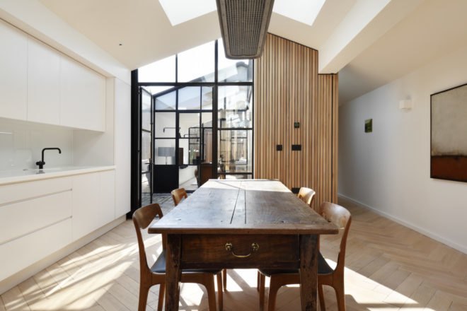 Antique-looking dining table and herringbone wood floors