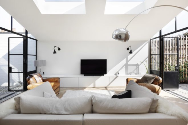 White couch facing a flat screen TV
