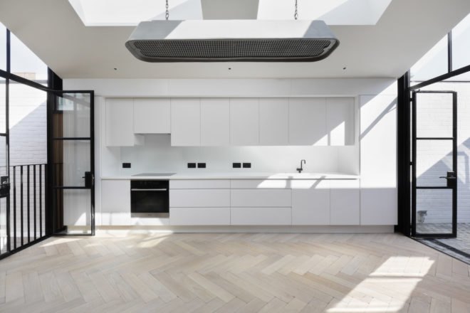 Bright white kitchen and herringbone wood floors