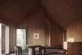 Rendering of a living room with pitched roof and stone tables and chairs.