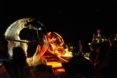 A metal dung beetle sculpture lit up at night