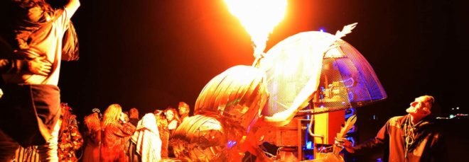 A metal dung beetle shooting flames into the air at night
