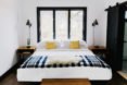 hotel bed with checkered blanket
