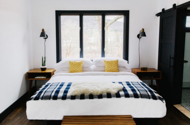 hotel bed with checkered blanket