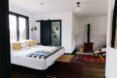 hotel bed with checkered blanket