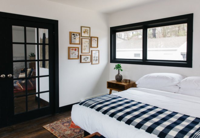 hotel bed with checkered blanket