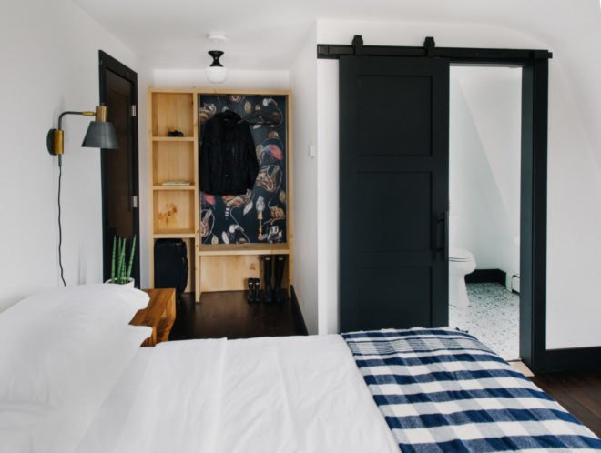 hotel bed with checkered blanket